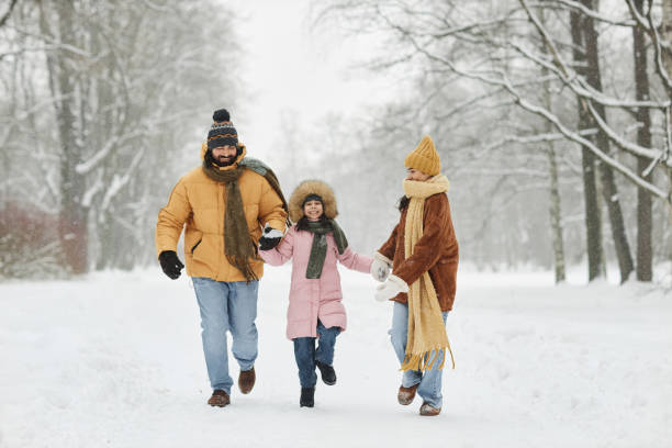 istock Family Holding Hands in Winter 2182339681