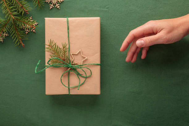 istock Christmas gift in zero waste eco-friendly pack with hand 2182342079