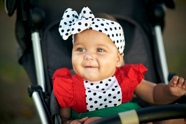 Cute girl in a baby stroller