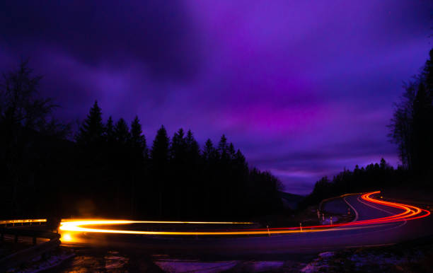 istock Car light lines on a mountain asphalt road in the evening 2182346925