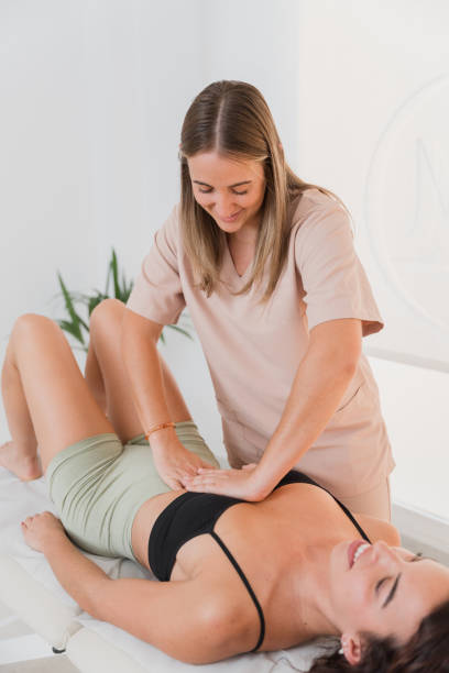 istock Physiotherapist performing osteopathy treatment on patient's abdomen 2182350212