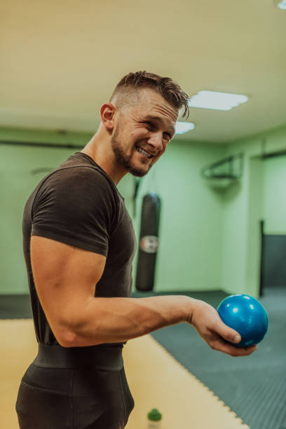 istock A young fit man doing warm up exercise before workout at gym. 2182350904