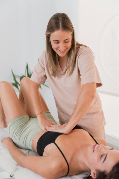 istock Physiotherapist performing osteopathy treatment on patient's abdomen 2182351777