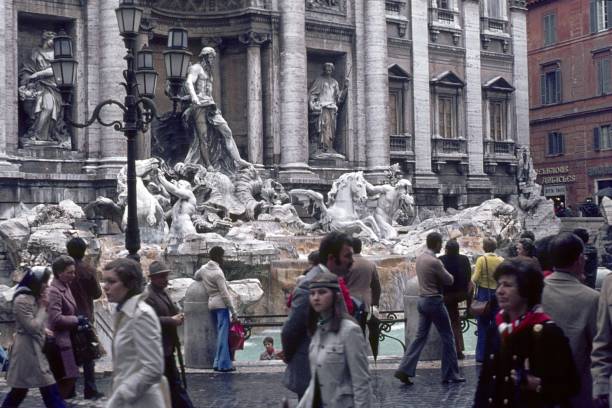 Rome, Lazio, Italy, 1974. At the busy Trevi Fountain in Rome. Furthermore: tourists and Romans.