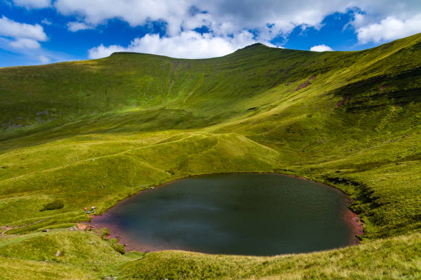 istock Small glacial formed lake beneath higher mountains 2182363062