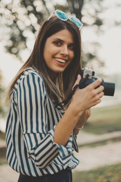 istock Young woman with an instant camera 2182364583