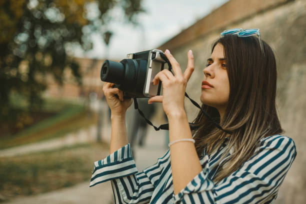 istock Young woman with an instant camera 2182364656
