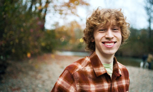 istock Laughing young man standing by a river during a hike 2182370041