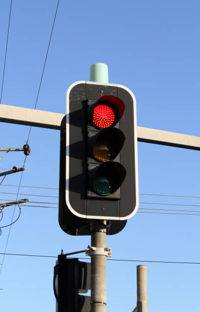 istock Red traffic light against a clear blue sky 2182372305