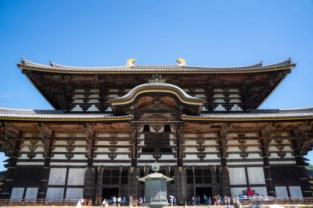 Japan, Kyoto - August 13, 2024: The Todaiji Temple in Nara, stands majestically against clear blue sky, surrounded by lush greenery, showcasing traditional Japanese architecture and cultural heritage