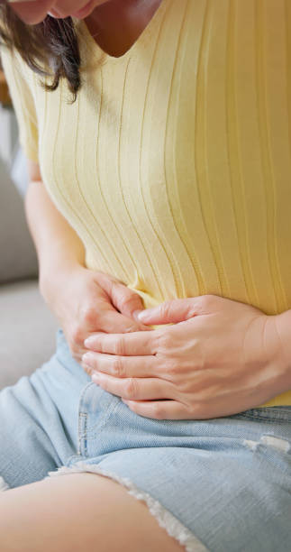 istock asian woman has belly pain 2182391693