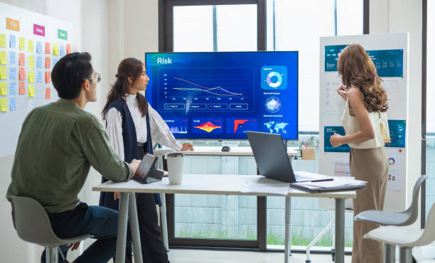 istock asian leader presenting a financial data and strategies in a modern office with charts and graphs displayed on a large screen 2182396830