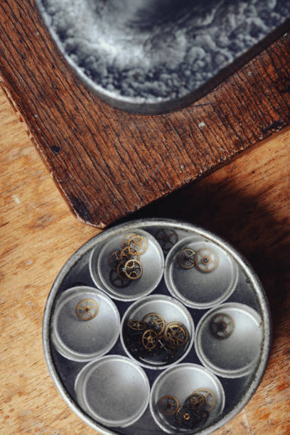 Watchmakers workbench holds compartmented tray of gears
