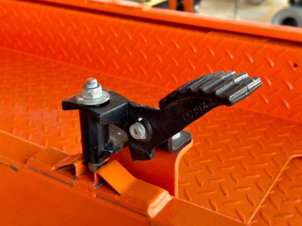 istock Orange Dump Trailer Foot Pedal Latch Detail 2182397430