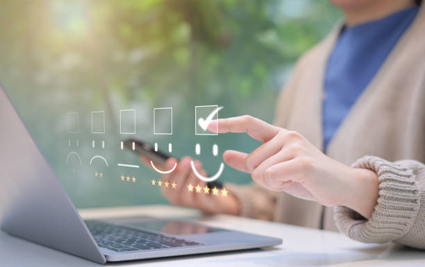 istock Customer review satisfaction feedback survey concept. Person interacts with laptop, giving a five-star rating using a digital feedback system, illustrating positive customer satisfaction and feedback. 2182404145
