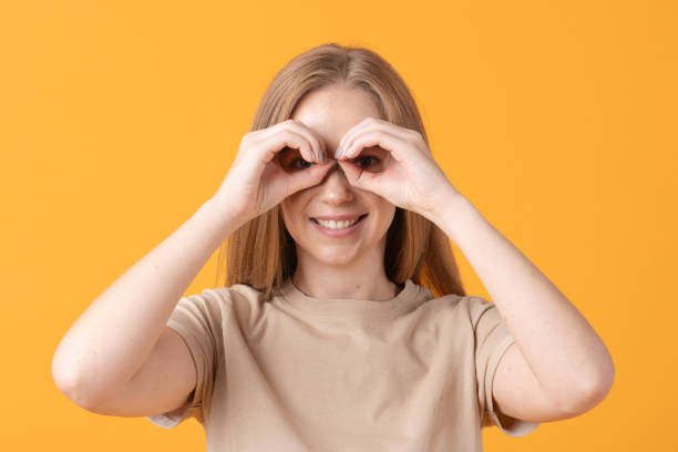 istock Cheerful Woman Making Binoculars Shape with Her Hands 2182409806