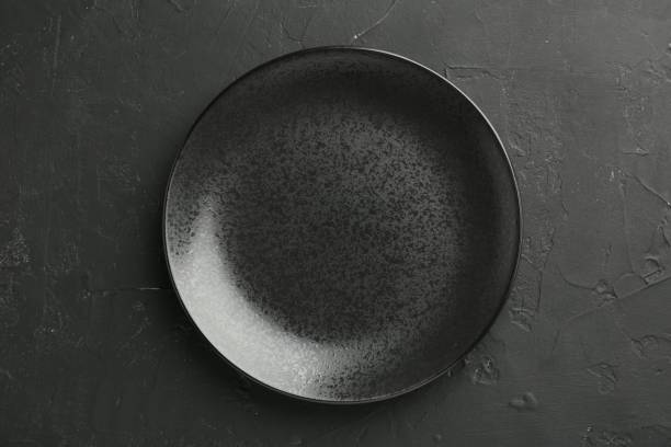 istock Beautiful ceramic plate on black background, top view 2182409969