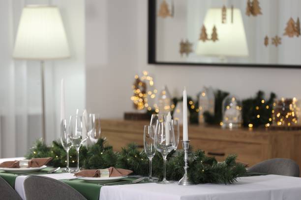 istock Christmas table setting with burning candles and festive decor in room 2182409970