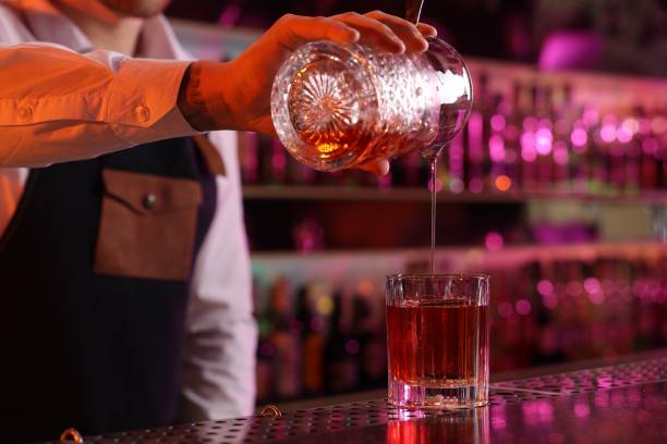 istock Bartender making fresh alcoholic cocktail at counter in bar, closeup 2182409989