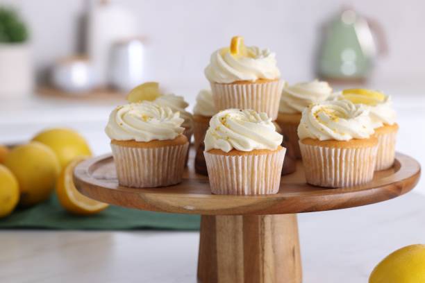 istock Delicious lemon cupcakes with white cream on table, closeup 2182410320