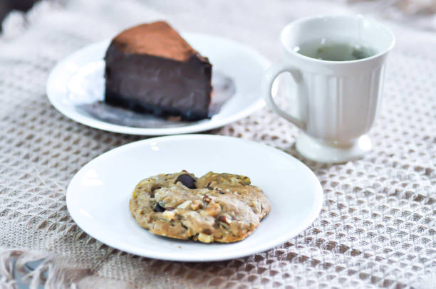 almond cookie , hot tea and chocolate cake for serve
