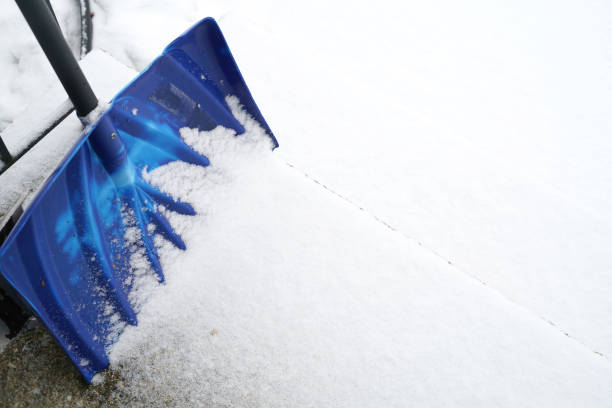 snow removal shovels in front door after snow