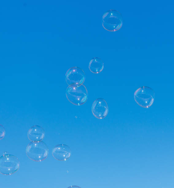istock A bunch of bubbles floating in the air on a clear blue sky 2182416590