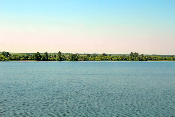 Summer rural landscape with an open-air lake.