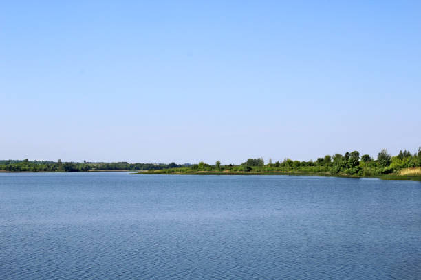 Summer wide lake under the blue sky.