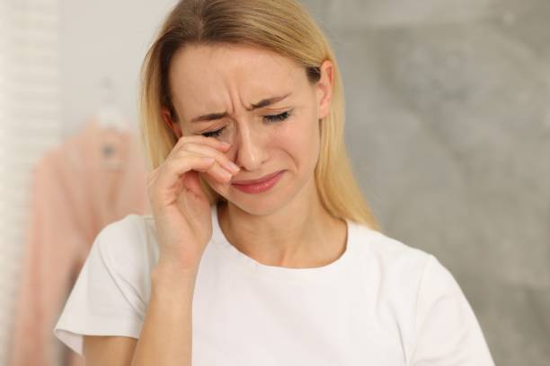 istock Sad woman with smeared mascara crying indoors 2182418108