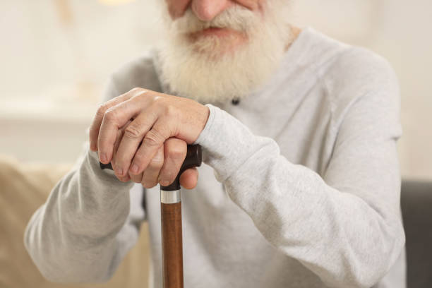 istock Senior man with walking cane indoors, closeup 2182418971