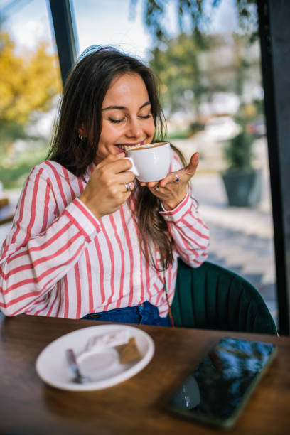 istock Beautiful woman enjoys drinking coffee. 2182421058