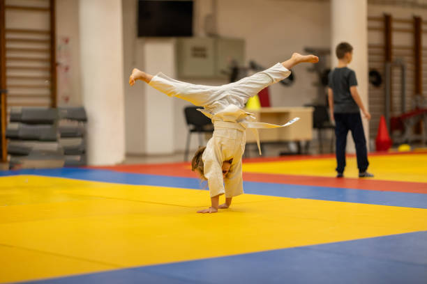 istock Girl performing handstand during judo practice indoors 2182426000
