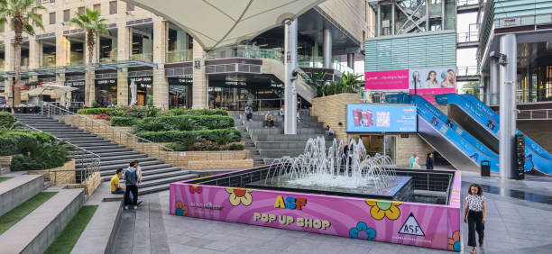 view of Amman Jordan mall with shoppers standing next to the fountain in the middlle