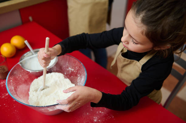 istock Young girl in kitchen baking and learning to mix ingredients 2182426862