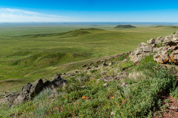 istock View from above over the green, lush steppe in eastern Mongolia with a blue sky and a light haze on the horizon 2182427250