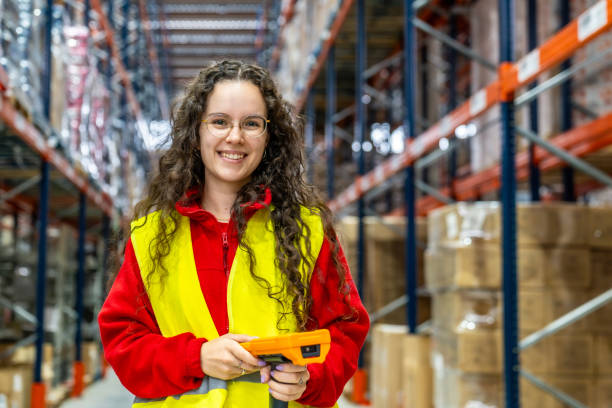 istock Happy employee holding a scanner in a distribution warehouse 2182429478