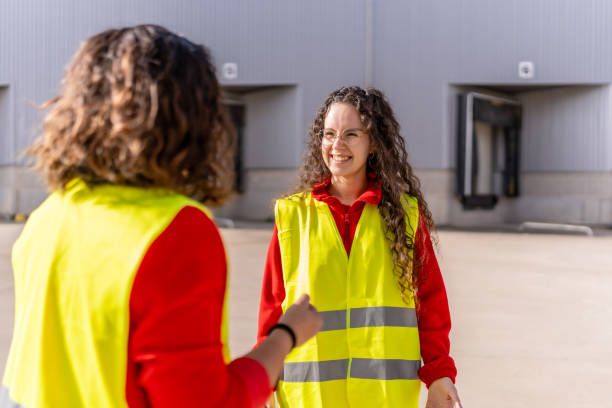 istock Manager and worker talking outside the parking of distribution warehouse 2182429566