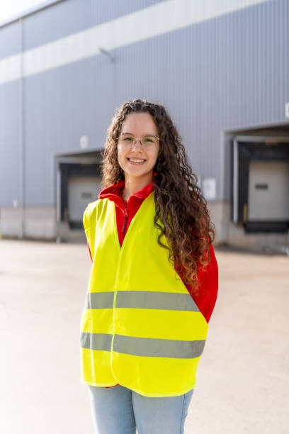 istock Happy warehouse woman worker standing outside the building 2182429573