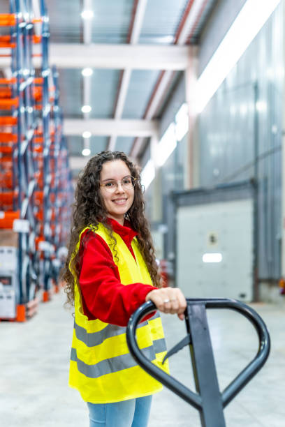 istock Woman with low lift forklift in a distribution warehouse 2182429596