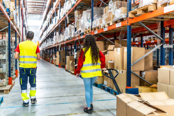 istock Workers of warehouse picking packages from shelves 2182429636