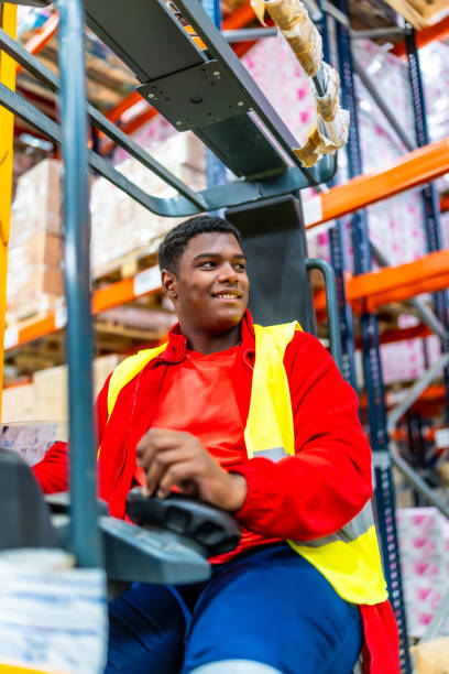 istock Happy worker in a forklift working in a storage warehouse 2182429716