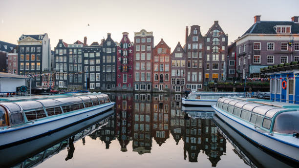 istock Exploring the reflective canals of Amsterdam during a serene autumn sunrise 2182430155