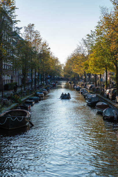 Autumn tranquility in Amsterdam's canals with colorful trees lining the serene waters