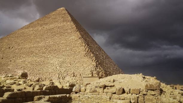 istock Great pyramid at Giza during a stormy day. clouds make a striking contrast over the pyramid 2182436173