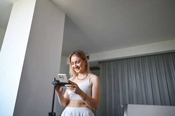 istock woman vlogging with mobile phone. 2182442625