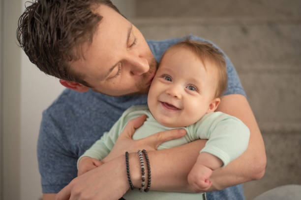 istock Father kisses his baby son 2182442855