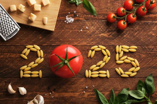 2025 figures with Italian ingredients on a rustic wooden background, tomatoes, pasta, basil and parmesan
