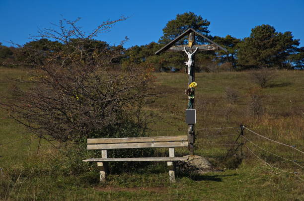 Cross against a cloudy sky, backlit