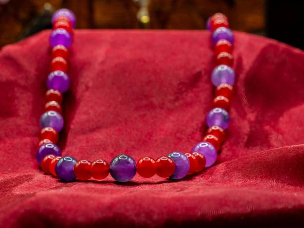 istock display of ancient medieval colored pearl necklace on a red fabric 2182448119